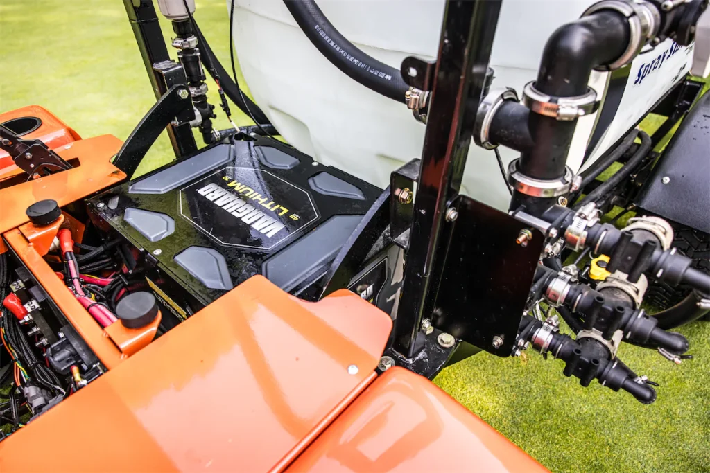 Smithco Spray Star 1200 E showcasing lithium battery, control panel, and spray system components on a turf maintenance vehicle.